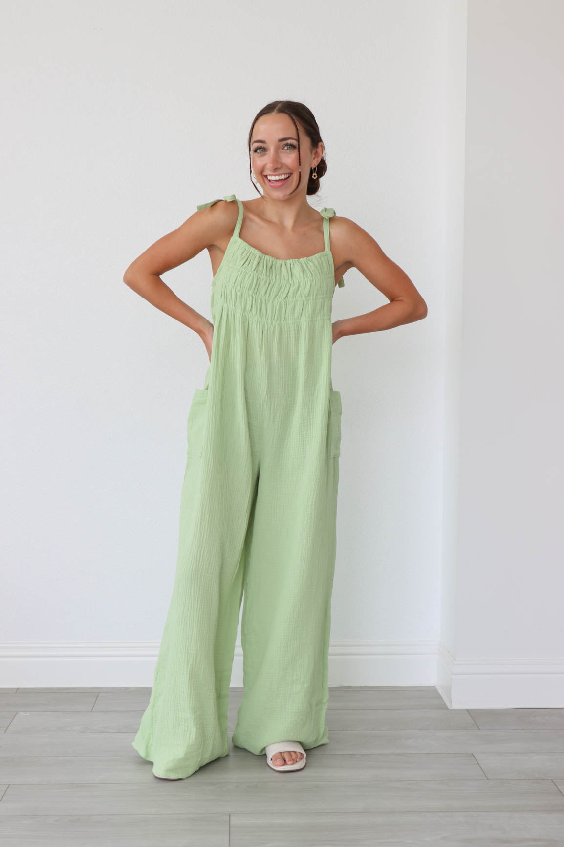 girl wearing lime green fabric long jumpsuit