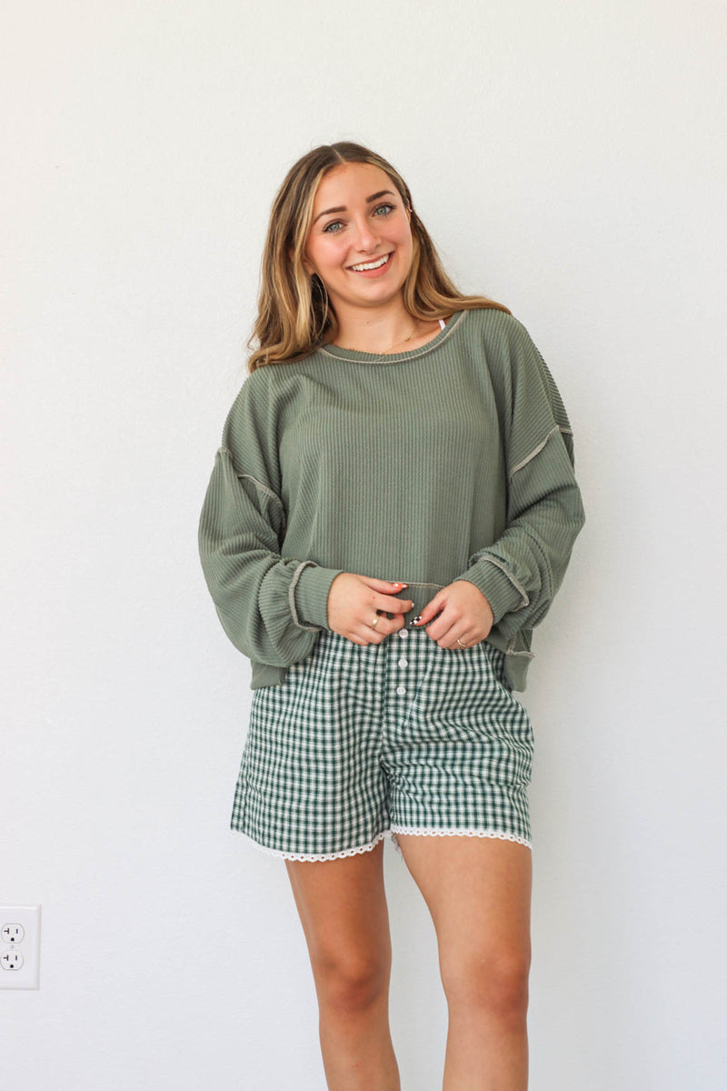 girl wearing green gingham boxer shorts