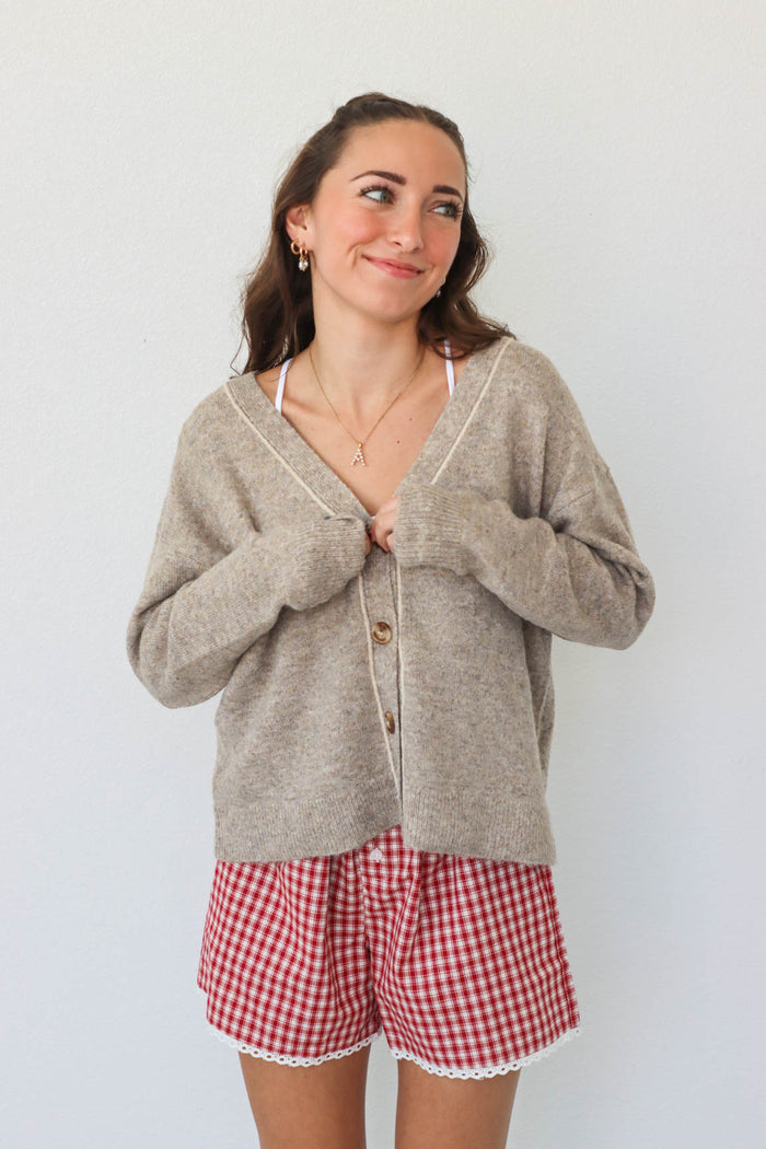 girl wearing tan knit cardigan