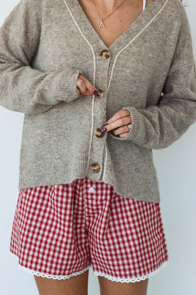 girl wearing tan knit cardigan