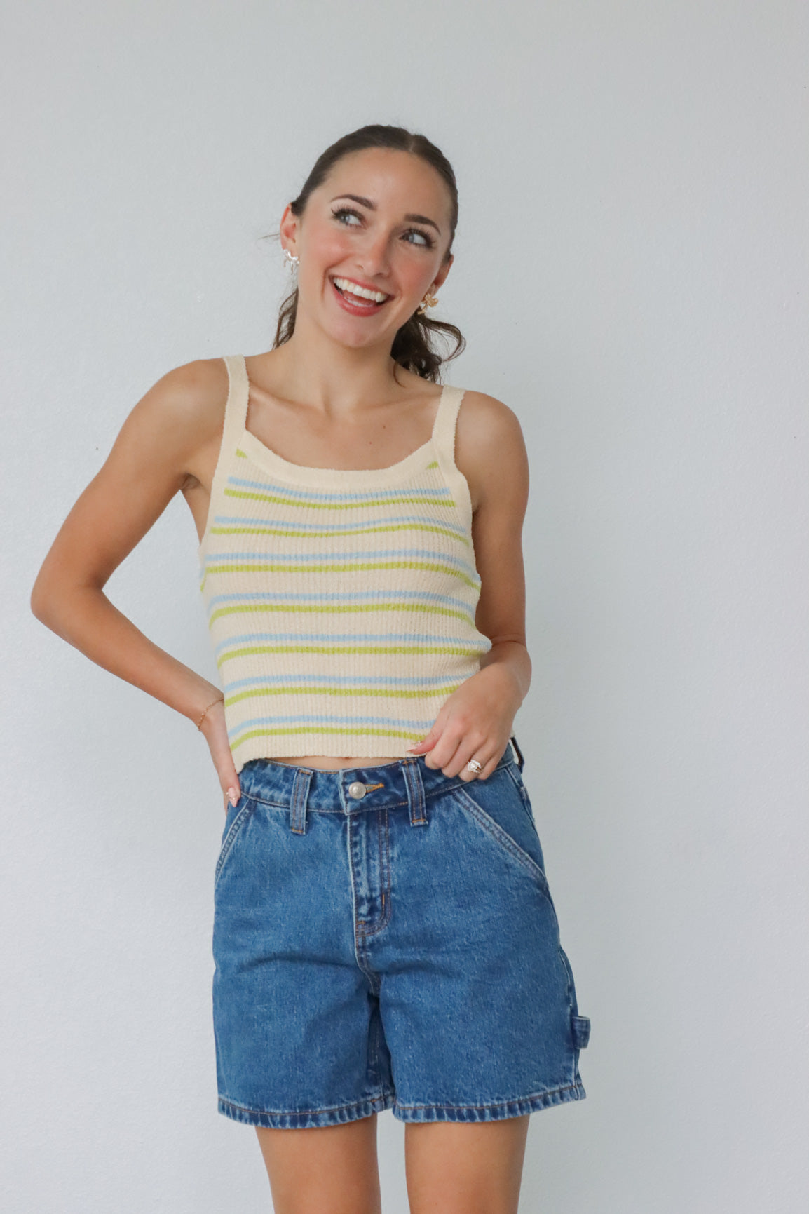girl wearing yellow, blue, and green striped tank top