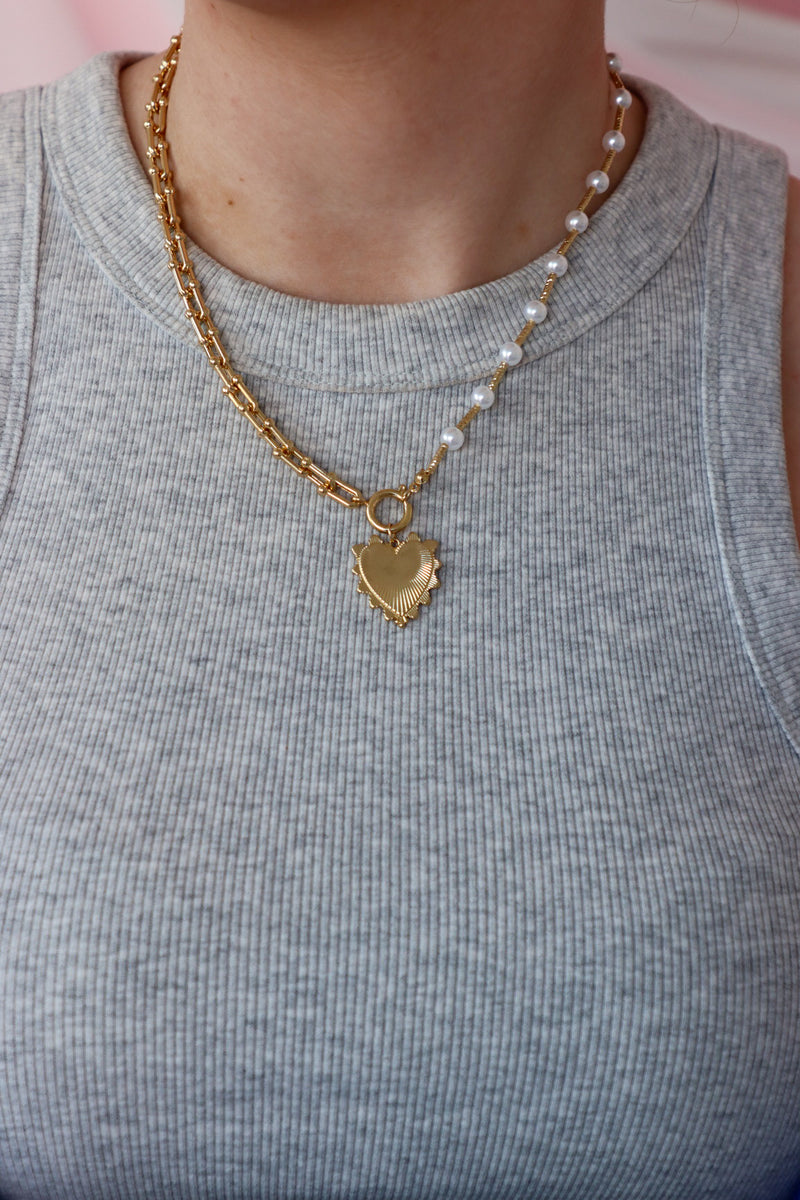 girl wearing gold and pearl heart chunky necklace