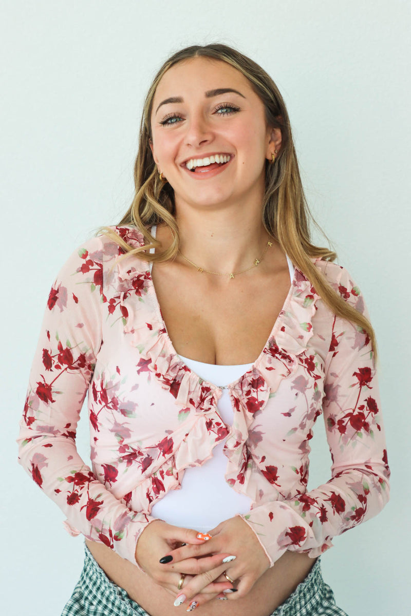 girl wearing sheer pink floral long sleeve top