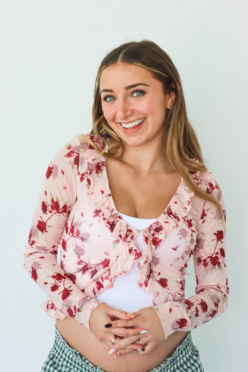 girl wearing sheer pink floral long sleeve top