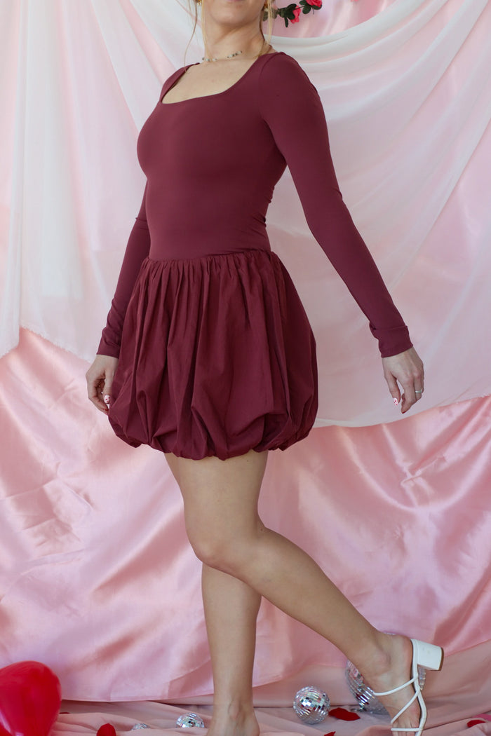 girl wearing maroon bubble dress