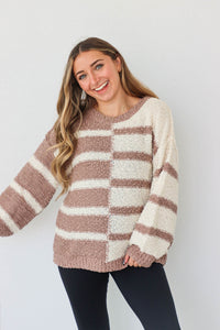 girl wearing tan & cream striped sweater