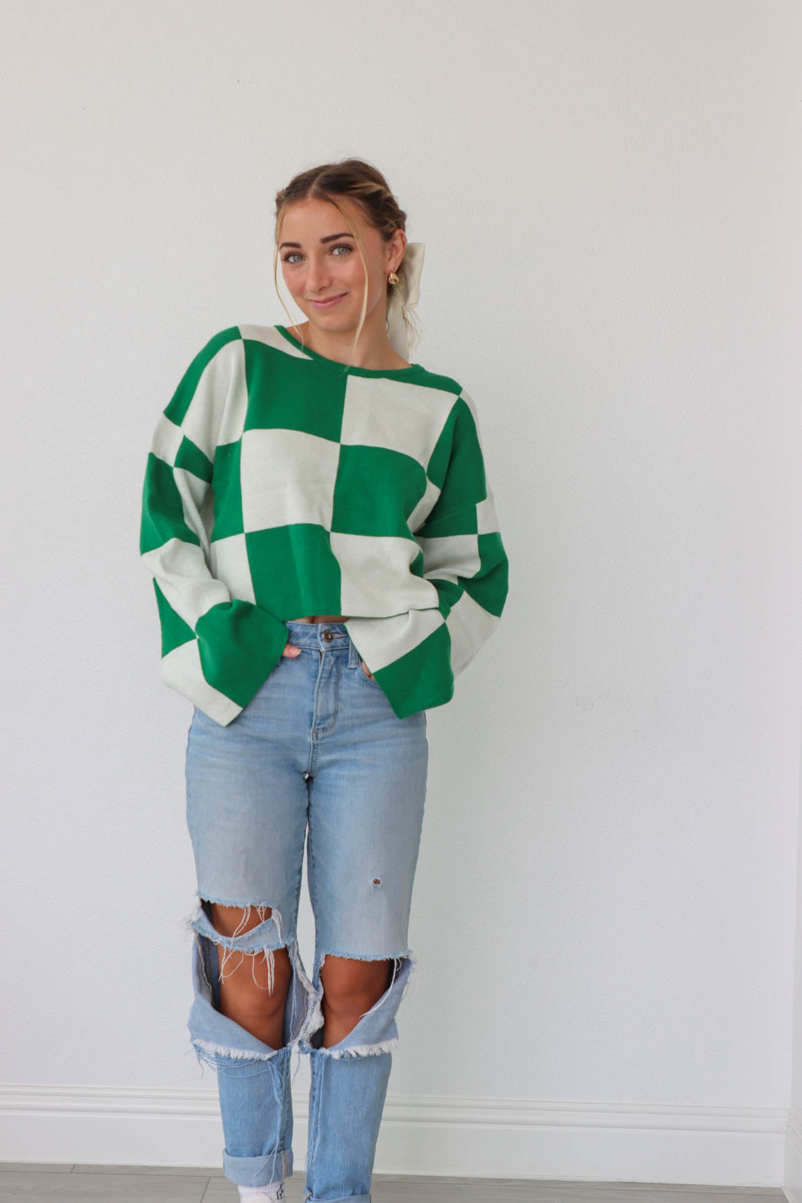 girl wearing green and white checkered print sweater