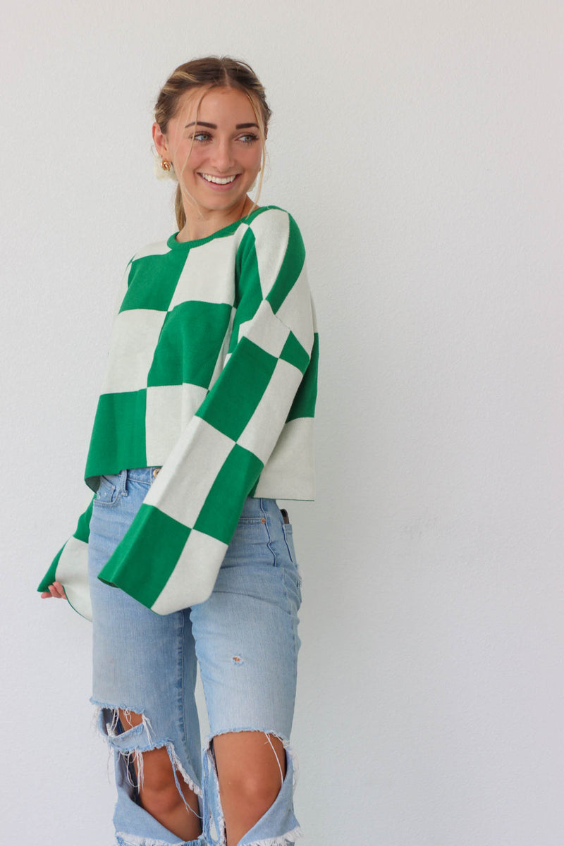 girl wearing green and white check print sweater