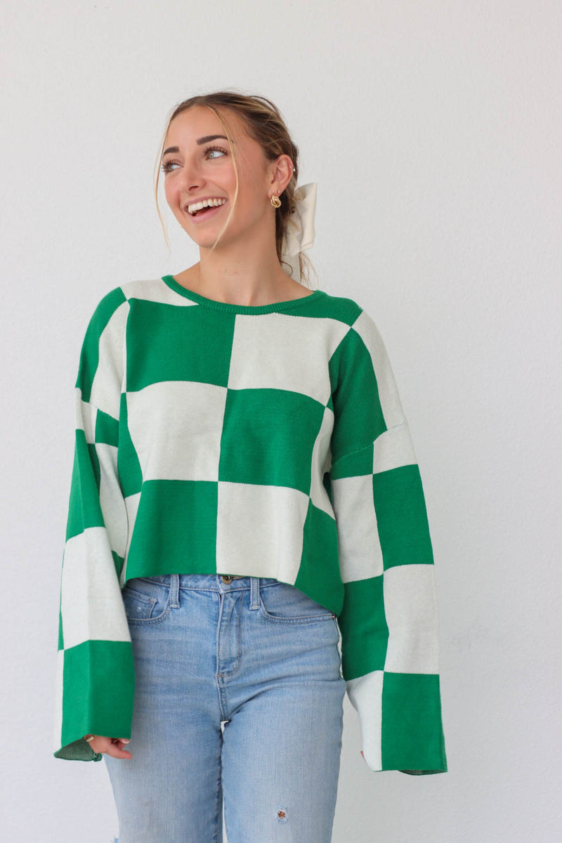 girl wearing green and white checkered print sweater