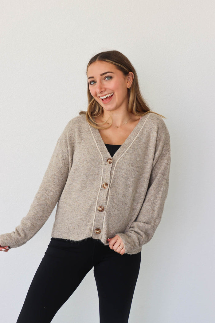 girl wearing tan knit cardigan