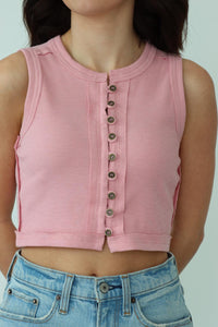 girl wearing pink button down cropped tank top