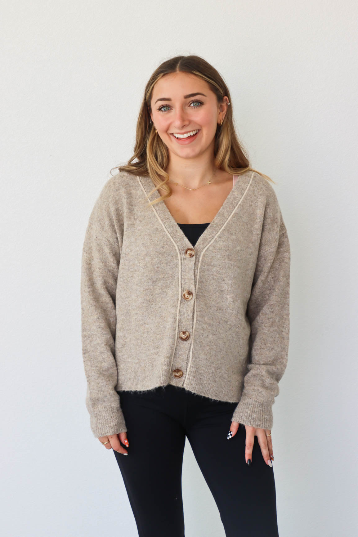 girl wearing tan knit cardigan