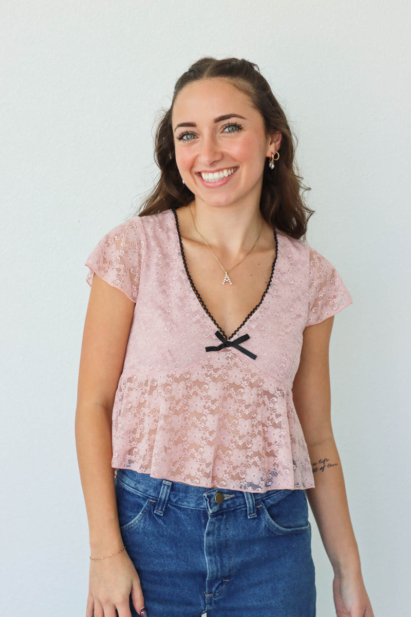 girl wearing pink lace top