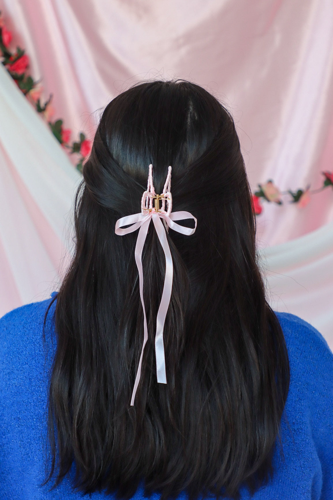 girl wearing pink silk hair bow clip