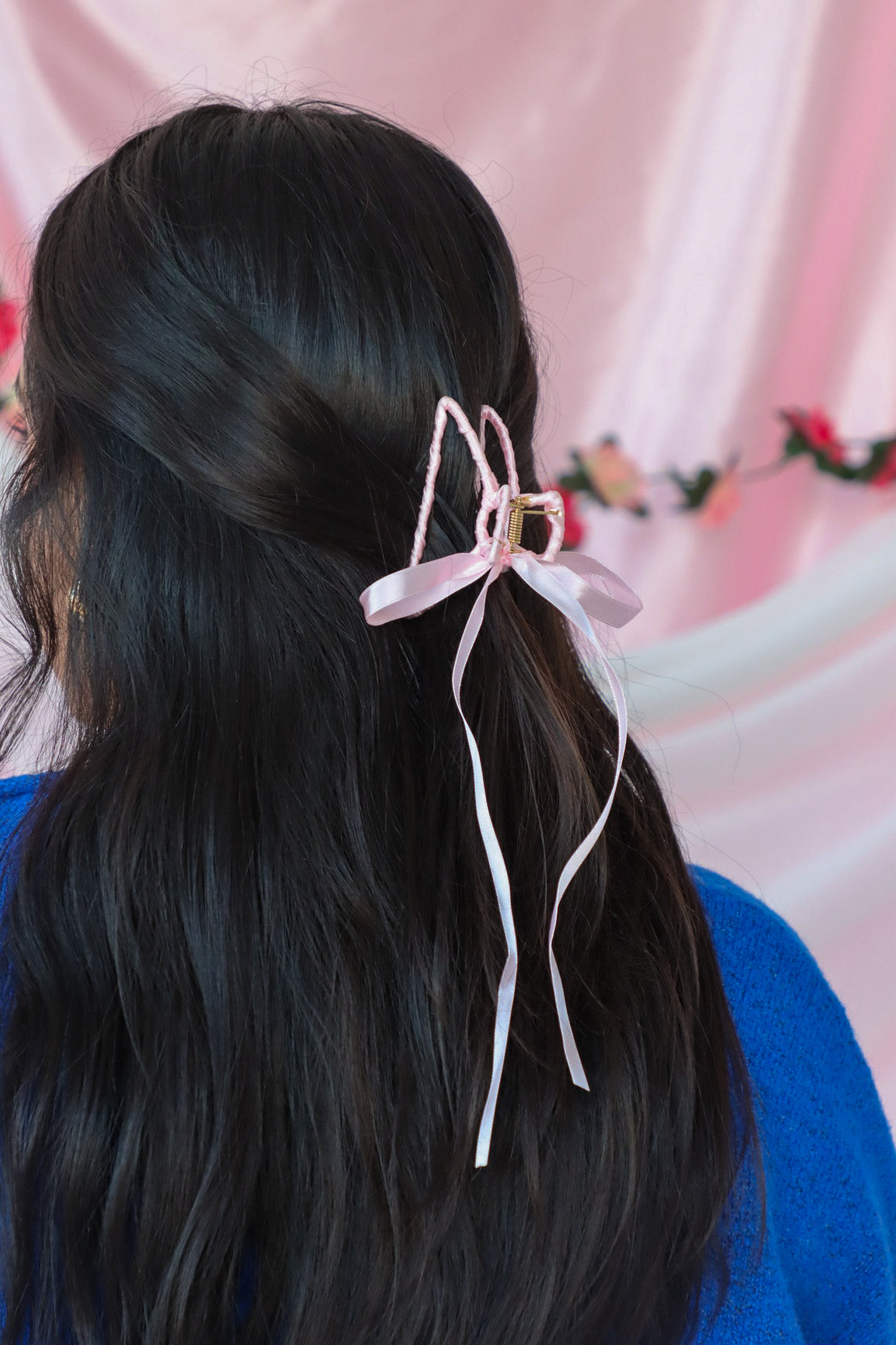 girl wearing pink silk hair bow clip