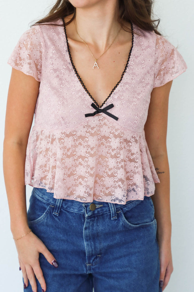 girl wearing pink lace top