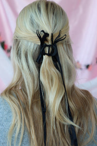 girl wearing black bow hair clip