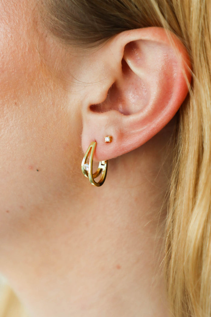 girl wearing gold hoop earrings