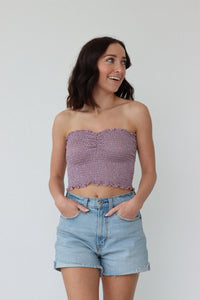 girl wearing purple sparkly strapless tube top