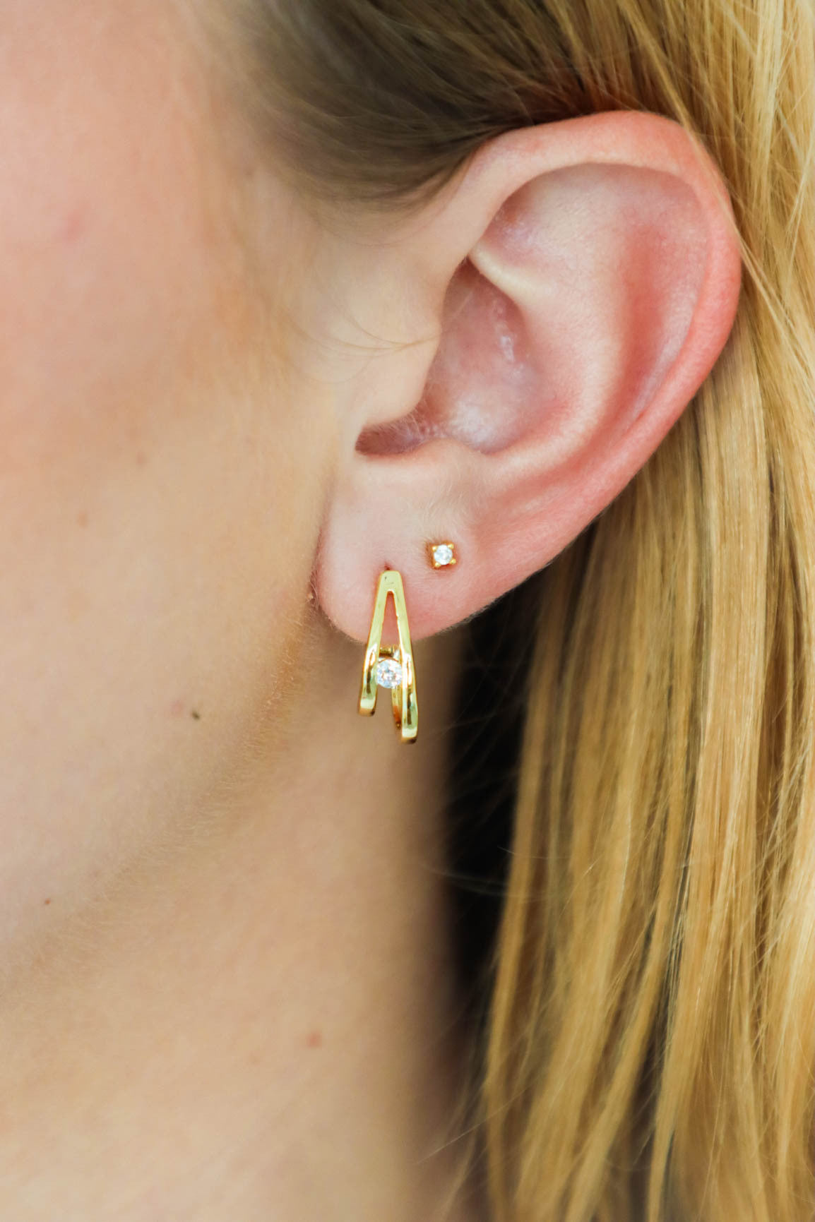 girl wearing gold hoop earrings