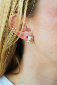 girl wearing gold and rhinestone cowboy boot stud earrings