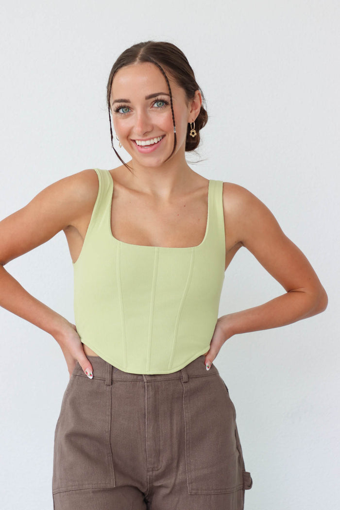 girl wearing light green corset tank top