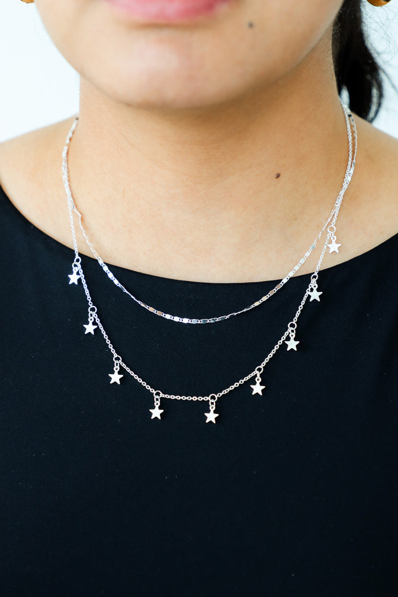 girl wearing silver star necklace