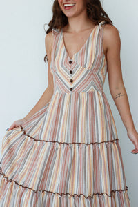 Woman wearing a striped dress with a plain background