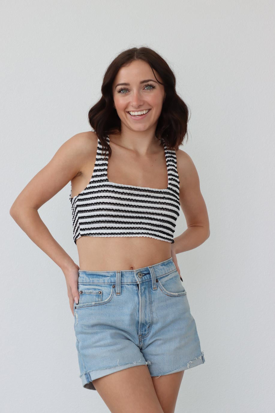 girl wearing black and white striped cropped tank top