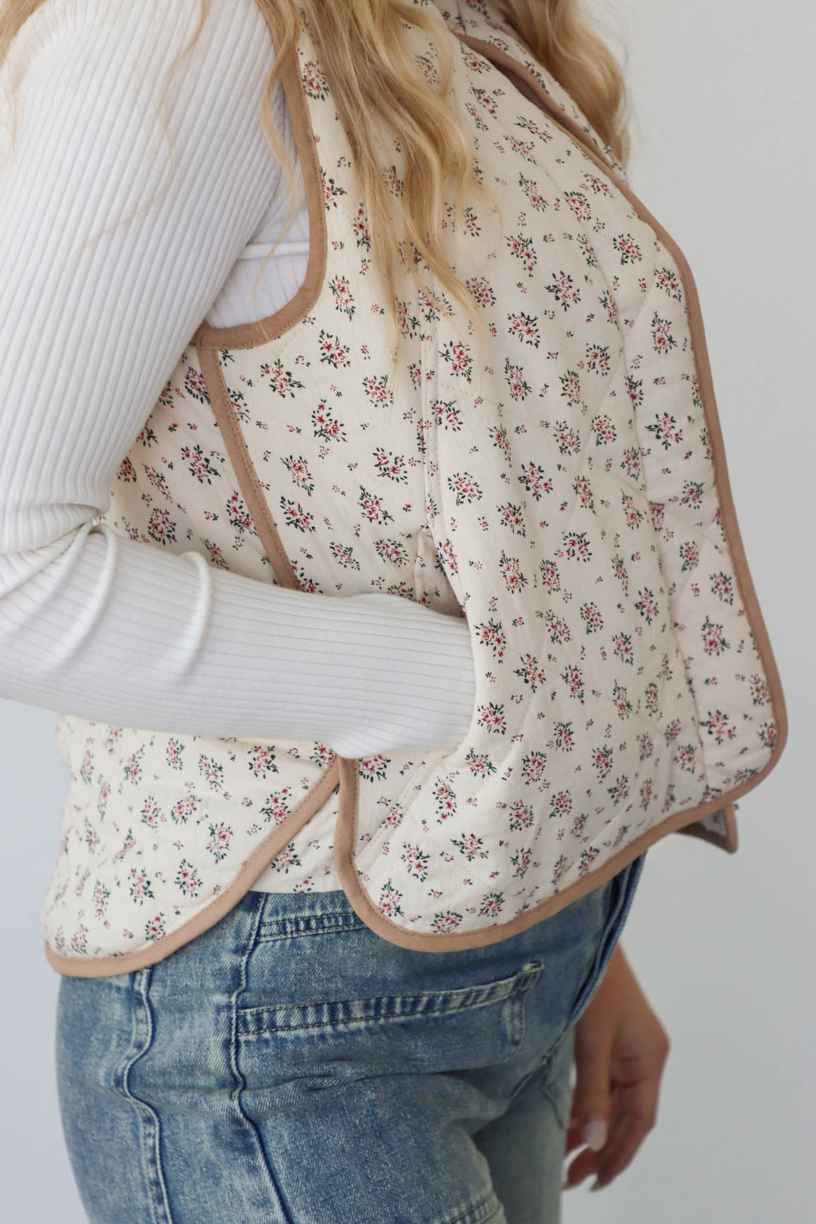 girl wearing cream quilt vest