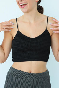 girl wearing cropped black ruched tank top