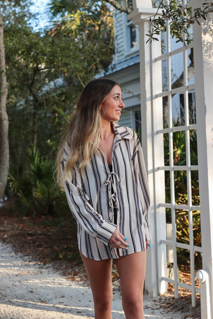 girl wearing cream and black striped long sleeved top