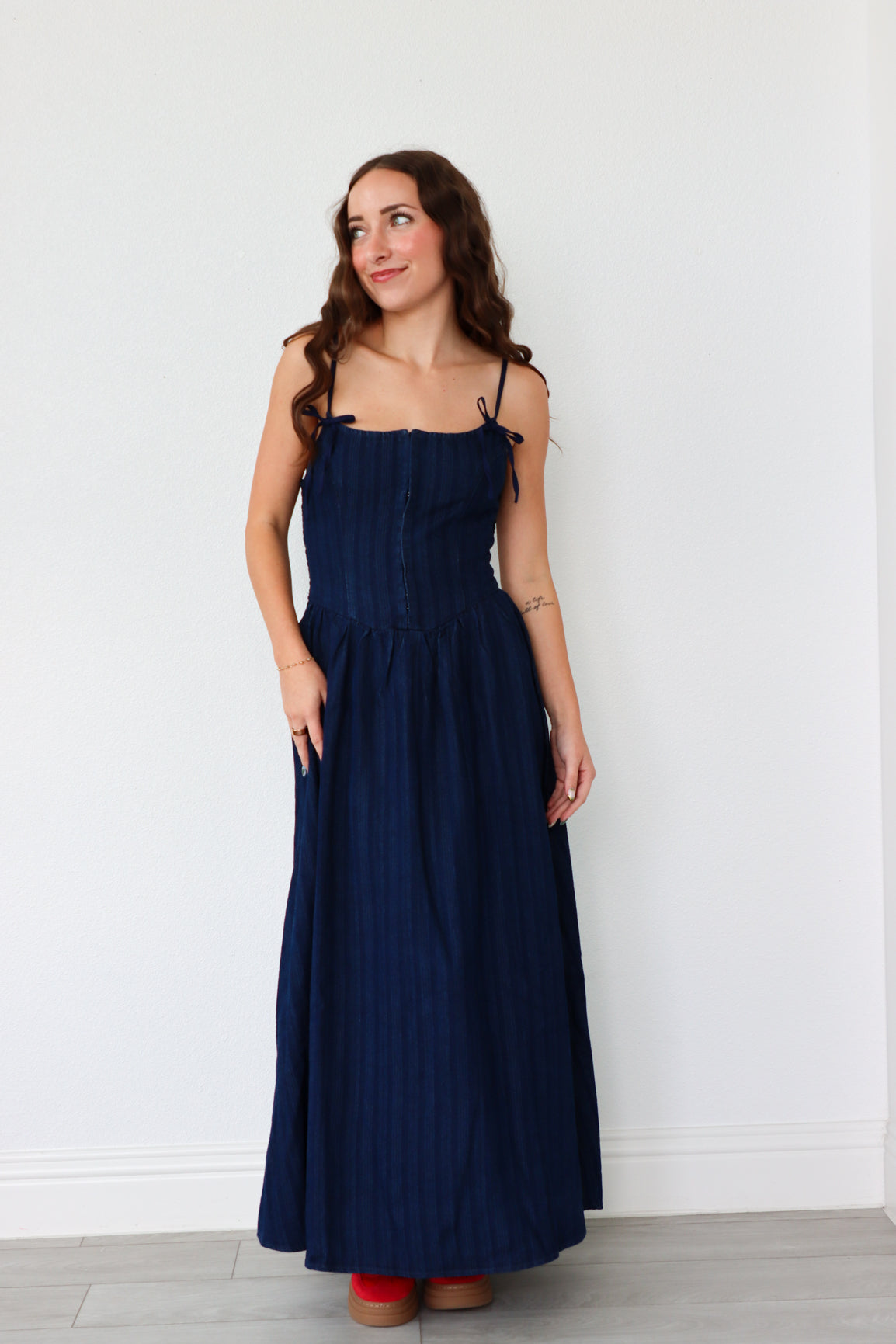 Woman wearing a navy blue dress against a white background