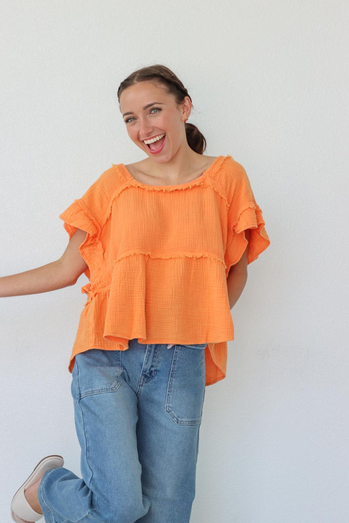 girl wearing orange short sleeved top