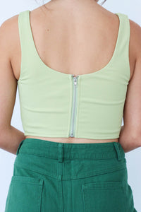 girl wearing light green corset tank top
