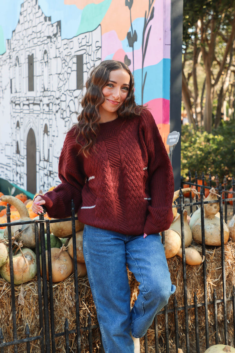 girl wearing dark red knit sweater