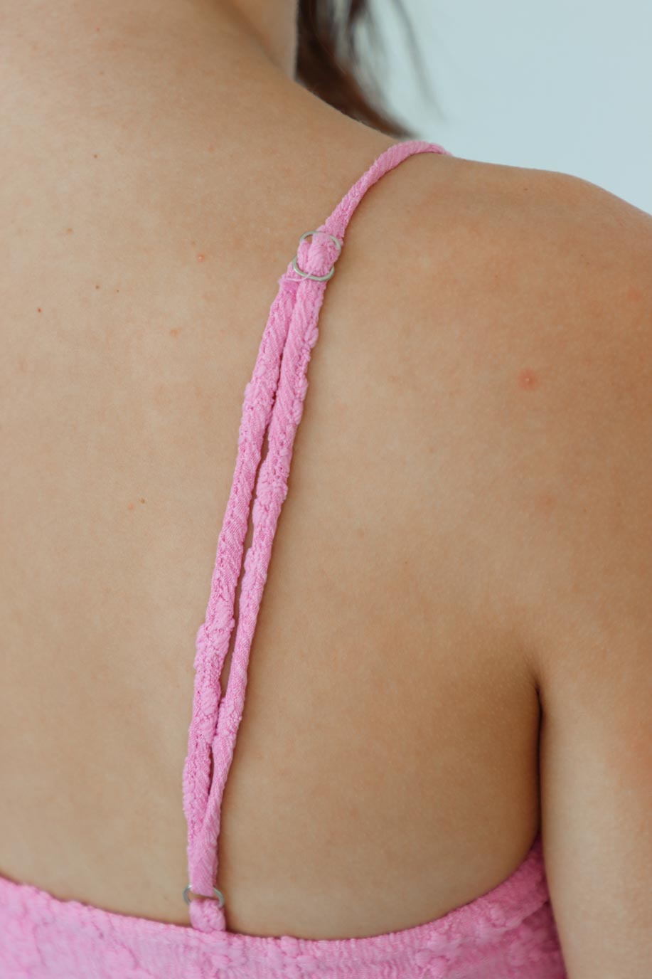 adjustable straps on pink floral bodysuit
