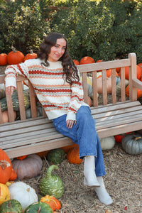 girl wearing cream multicolored knit sweater