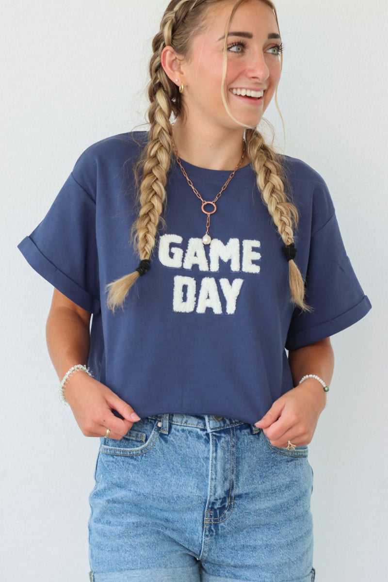 girl wearing blue "game day" t-shirt