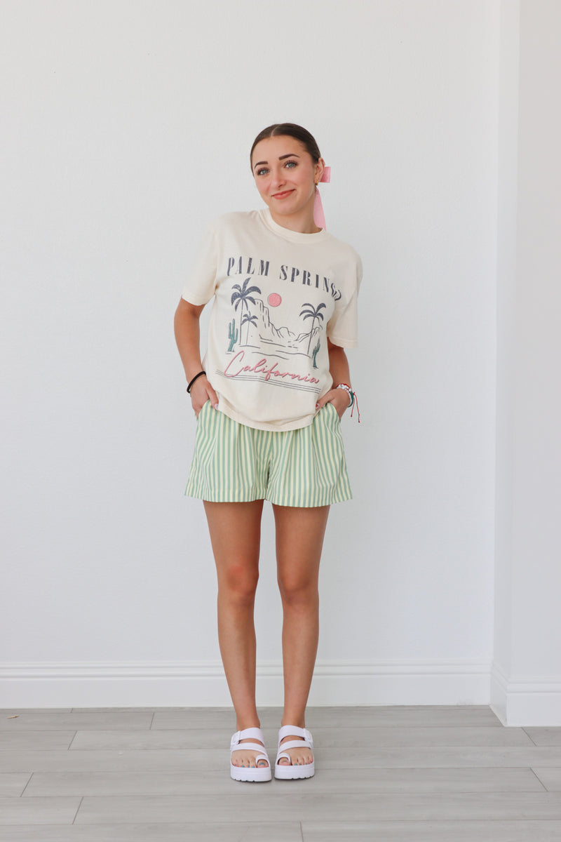 girl wearing green striped boxer-style shorts
