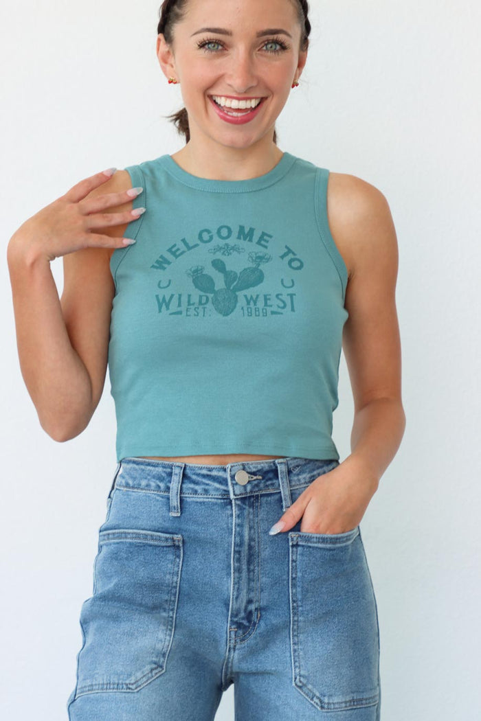 girl wearing "welcome to the wild west" teal tank top