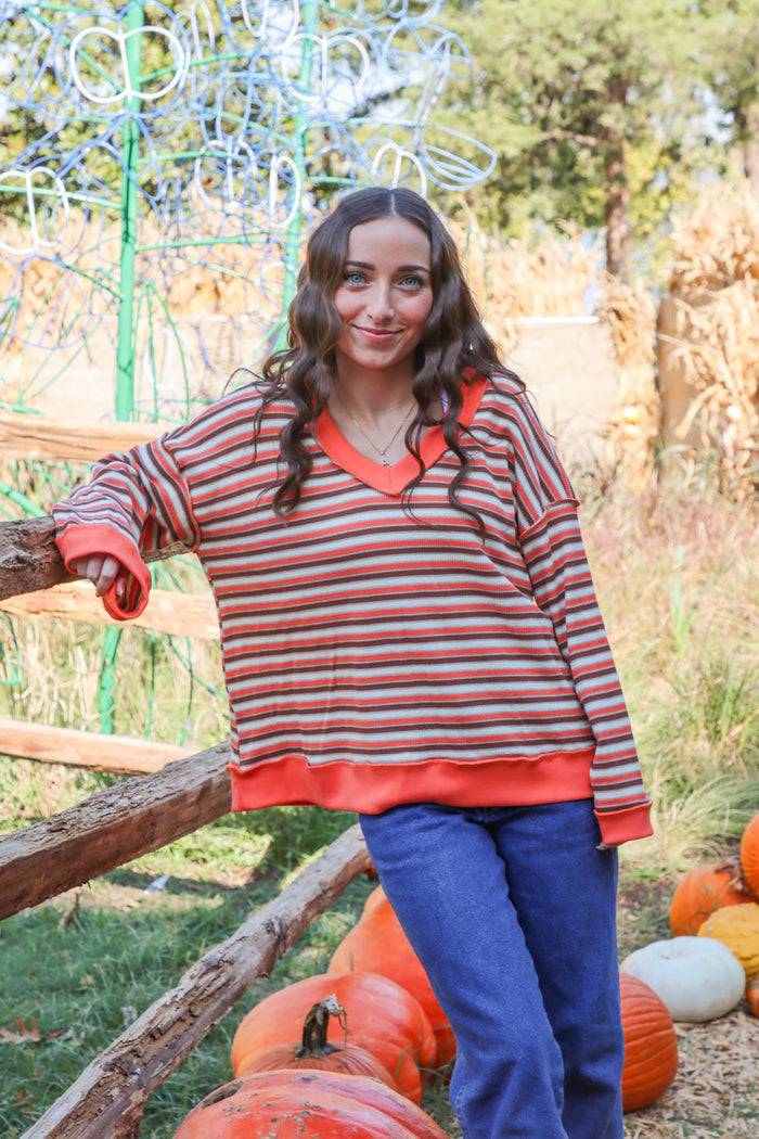 girl wearing orange striped top