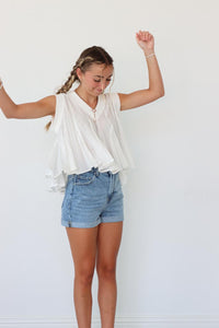 girl wearing white pleated tank top