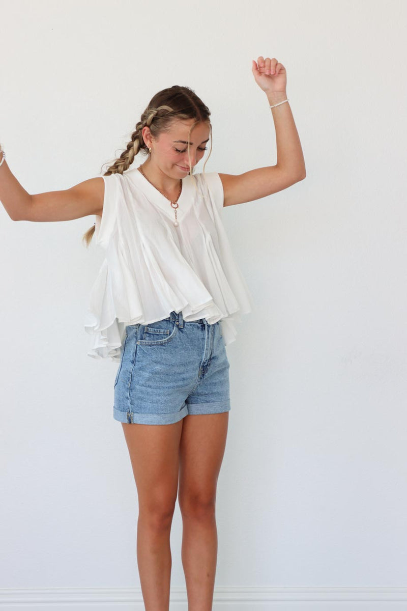 girl wearing white pleated tank top