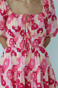 girl wearing short pink floral dress