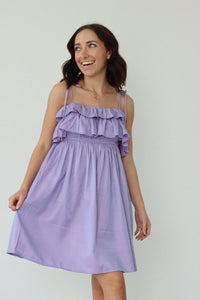 girl wearing short purple dress with thin straps