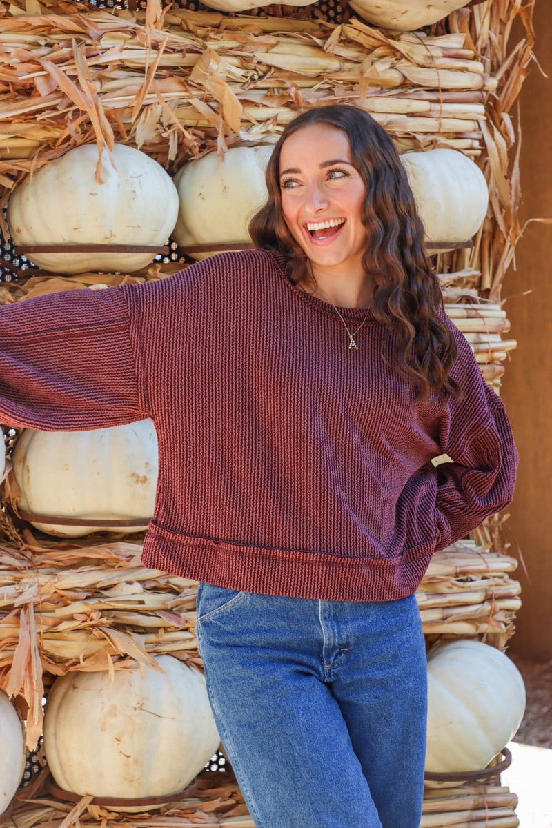 girl wearing dark red ribbed long sleeve top