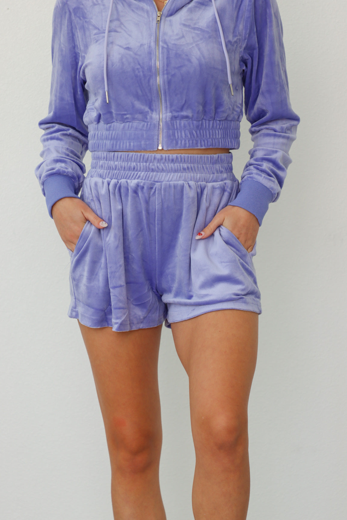 girl wearing lilac velour tracksuit