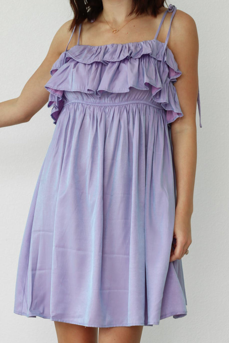 girl wearing short purple dress with thin straps