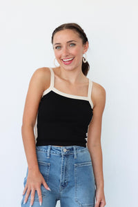 girl wearing black tank top with white contrast fabric detailing